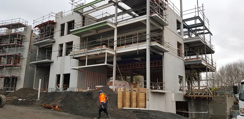 Site manager inspecting a concrete frame in winter conditions