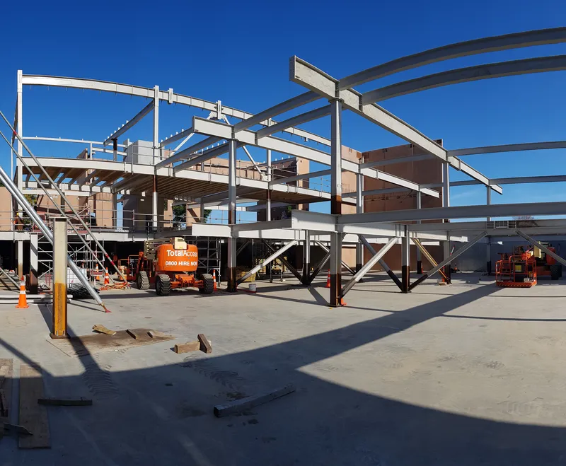 Structural steel frame under clear skies during pre-construction planning